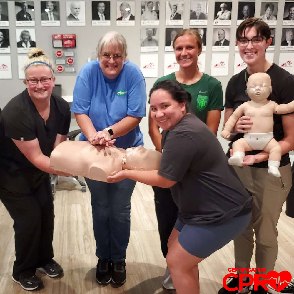 CPR training class in Denver with students practicing on mannequins.
